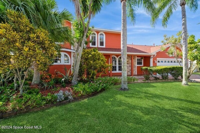 view of front of house with a garage and a front lawn