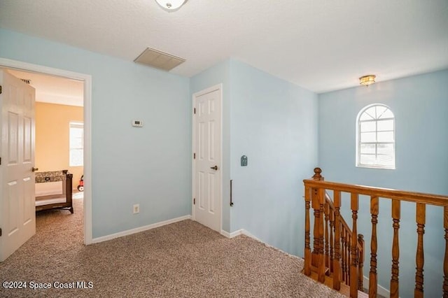 hallway featuring carpet flooring