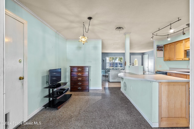 kitchen featuring a kitchen island, ornamental molding, hanging light fixtures, and decorative columns