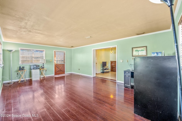 unfurnished living room with dark hardwood / wood-style floors and ornamental molding