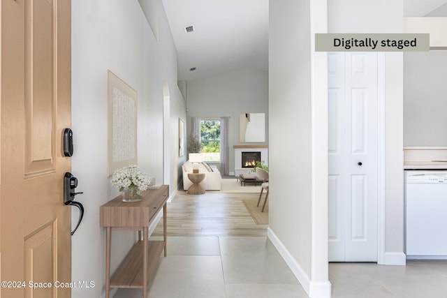 hallway featuring vaulted ceiling and light hardwood / wood-style floors