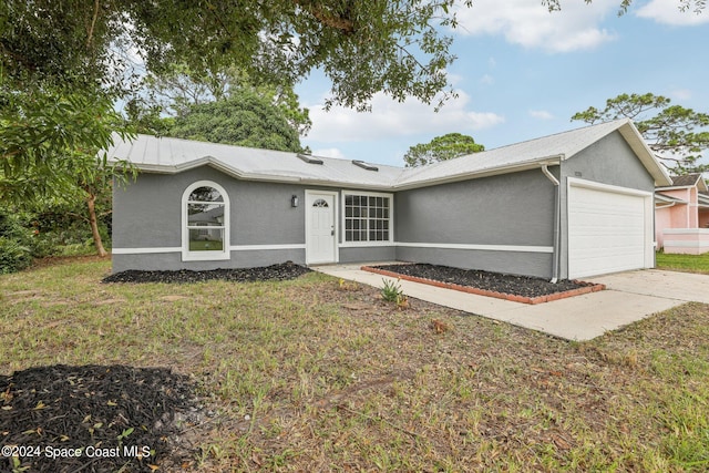 single story home featuring a front lawn and a garage