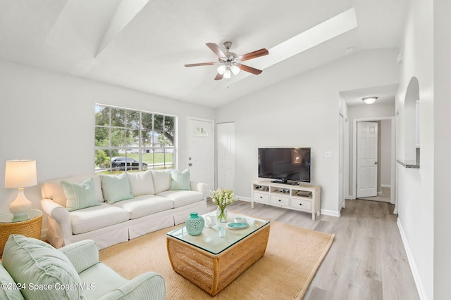 living room featuring light hardwood / wood-style floors, lofted ceiling, and ceiling fan