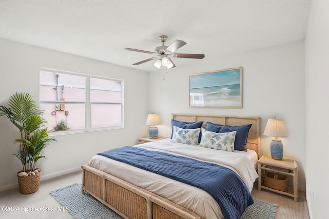 bedroom featuring light colored carpet and ceiling fan