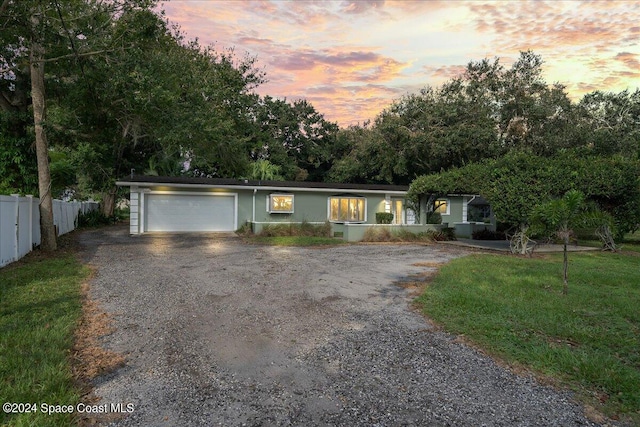 view of front of house with a yard and a garage