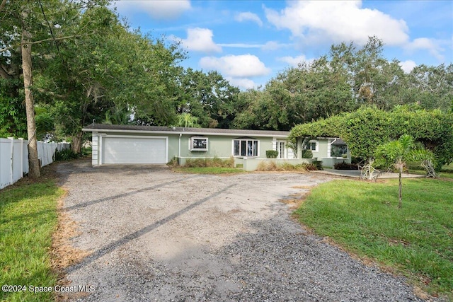 ranch-style house with a front lawn and a garage