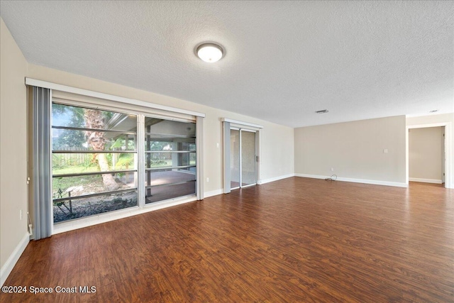 unfurnished room featuring hardwood / wood-style flooring and a textured ceiling