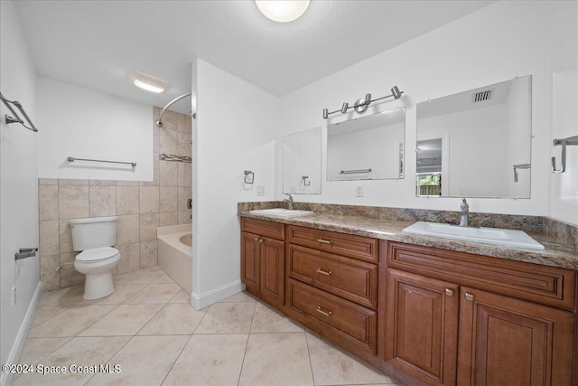 full bathroom with tile patterned floors, vanity, tile walls, toilet, and  shower combination