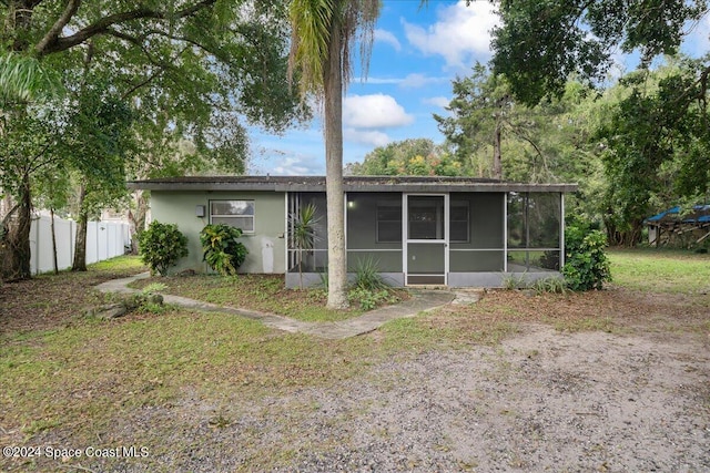 rear view of house with a sunroom