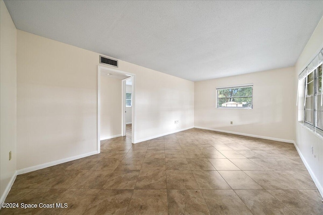 empty room featuring a textured ceiling