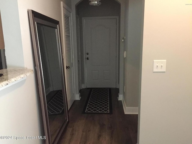 corridor with dark wood-type flooring