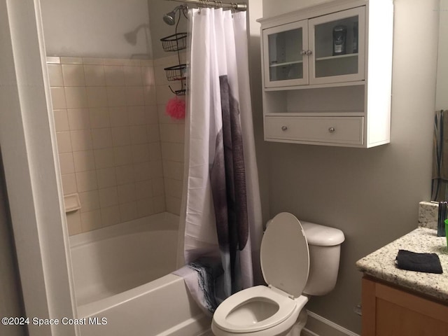 full bathroom with shower / bath combination with curtain, vanity, and toilet