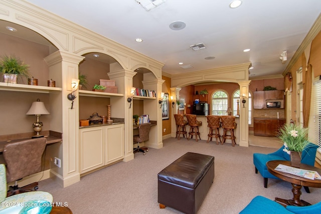 6470 Borasco Dr Unit 1108, Melbourne, FL 32940 - living room featuring ornate columns, an office area, recessed lighting, light colored carpet, and arched walkways