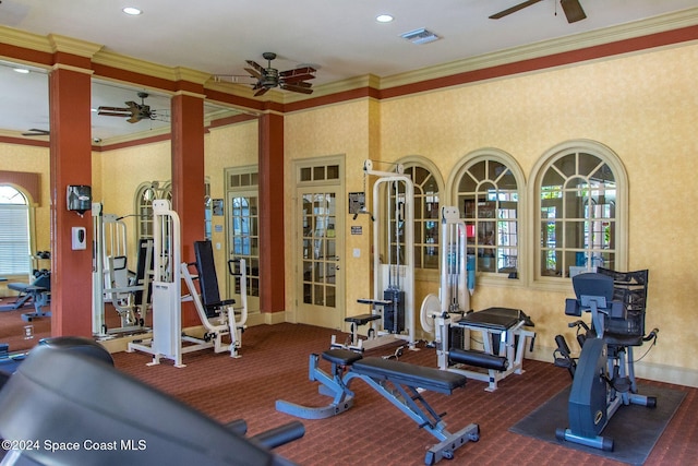 exercise room featuring ceiling fan, ornamental molding, and carpet floors