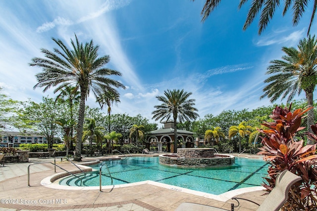 view of swimming pool with a gazebo and a hot tub