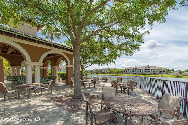 6470 Borasco Dr Unit 1108, Melbourne, FL 32940 - view of patio featuring outdoor dining area, a water view, and a residential view
