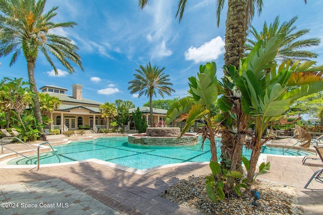 view of swimming pool featuring a patio area and a jacuzzi