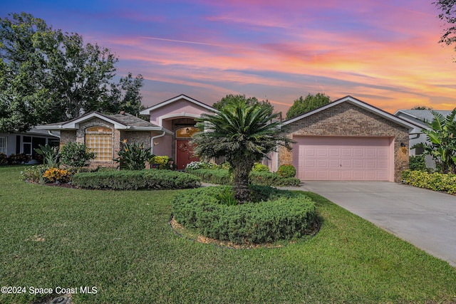 single story home with a garage and a lawn