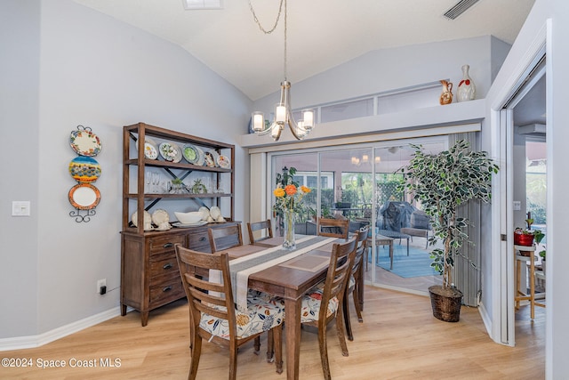 dining area featuring light hardwood / wood-style floors, a healthy amount of sunlight, and vaulted ceiling