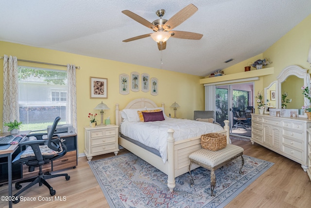 bedroom featuring lofted ceiling, light hardwood / wood-style floors, access to outside, and ceiling fan