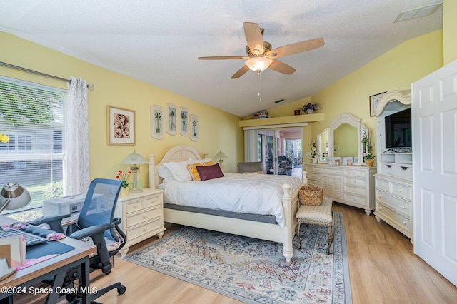 bedroom featuring light hardwood / wood-style flooring, ceiling fan, and multiple windows