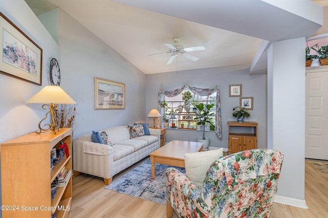 living room featuring light hardwood / wood-style flooring, lofted ceiling, and ceiling fan