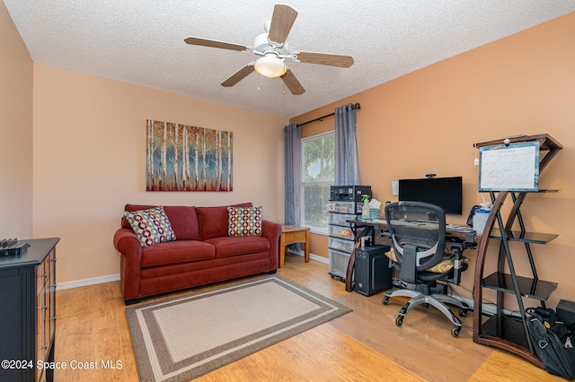 office with a textured ceiling, hardwood / wood-style flooring, and ceiling fan