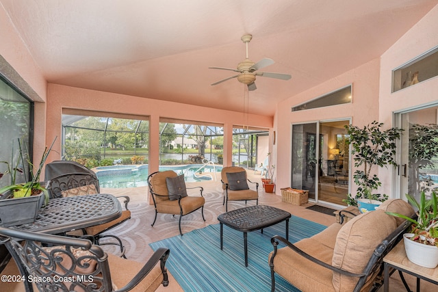 sunroom / solarium featuring ceiling fan, a swimming pool, and vaulted ceiling