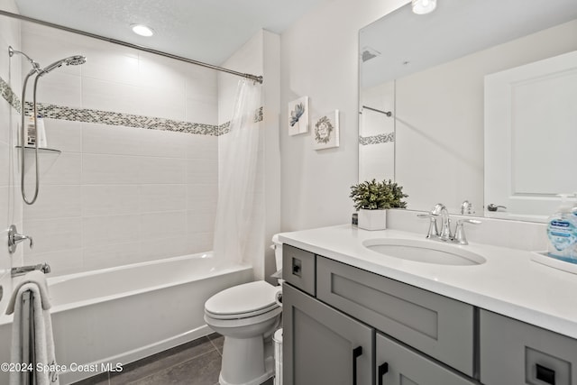 full bathroom with shower / bathtub combination with curtain, tile patterned flooring, vanity, and toilet