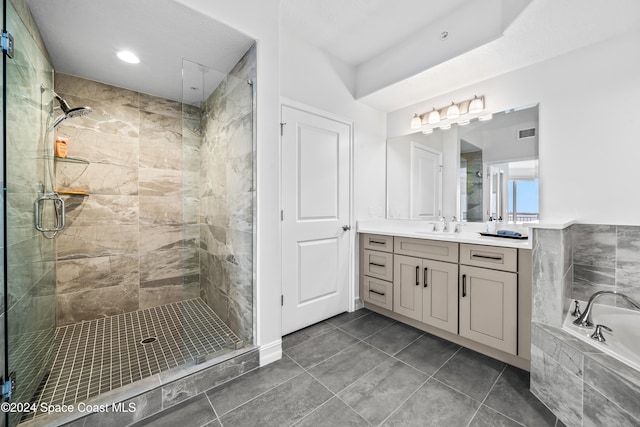 bathroom featuring tile patterned floors, vanity, and shower with separate bathtub