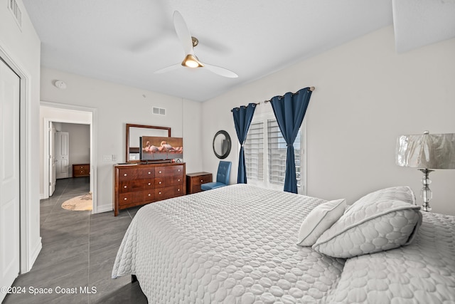 tiled bedroom with ceiling fan