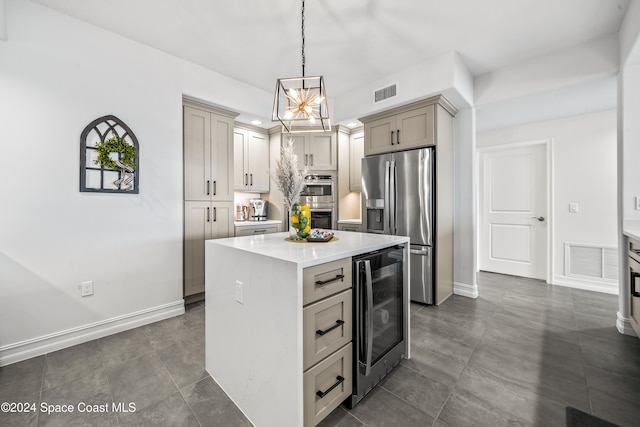 kitchen with stainless steel appliances, wine cooler, pendant lighting, gray cabinets, and a kitchen island