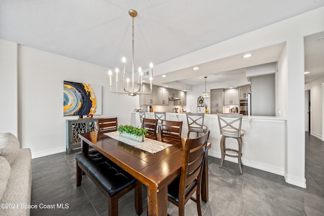 dining area featuring a textured ceiling and a notable chandelier