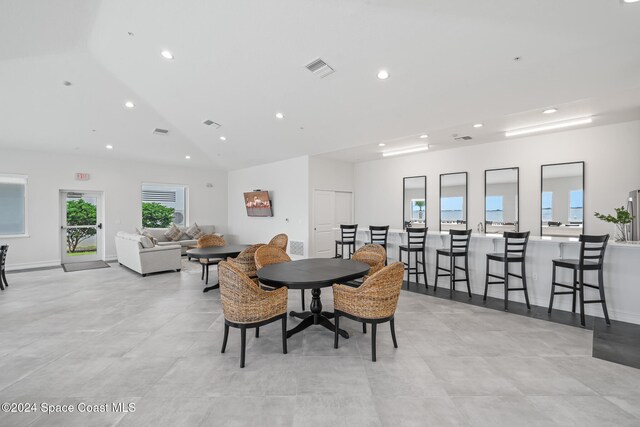 dining space featuring lofted ceiling