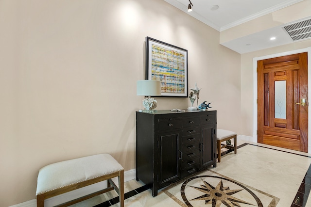 tiled entrance foyer featuring crown molding