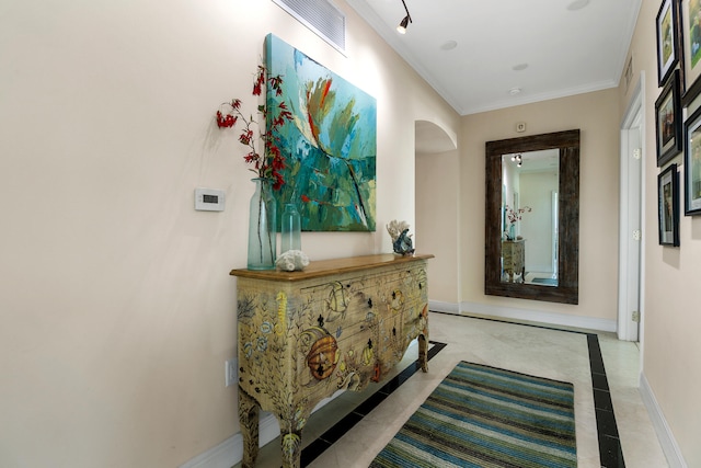 hall featuring ornamental molding and light tile patterned flooring