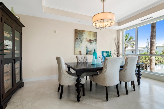 dining space featuring ornamental molding and an inviting chandelier