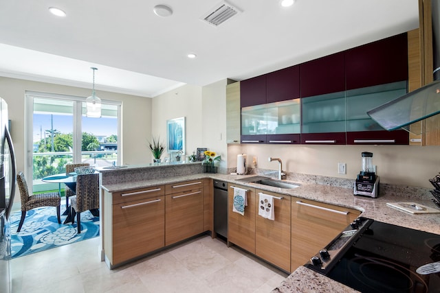 kitchen featuring kitchen peninsula, sink, crown molding, decorative light fixtures, and light stone counters