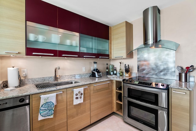 kitchen with light stone counters, wall chimney exhaust hood, sink, and stainless steel range with electric cooktop