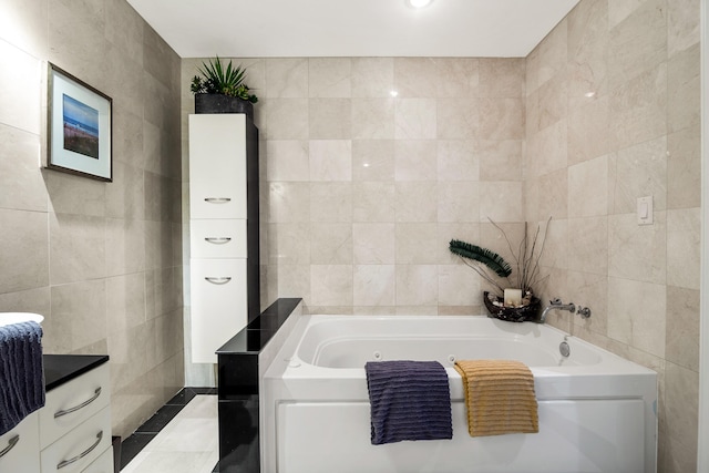 bathroom with vanity, a tub to relax in, and tile walls