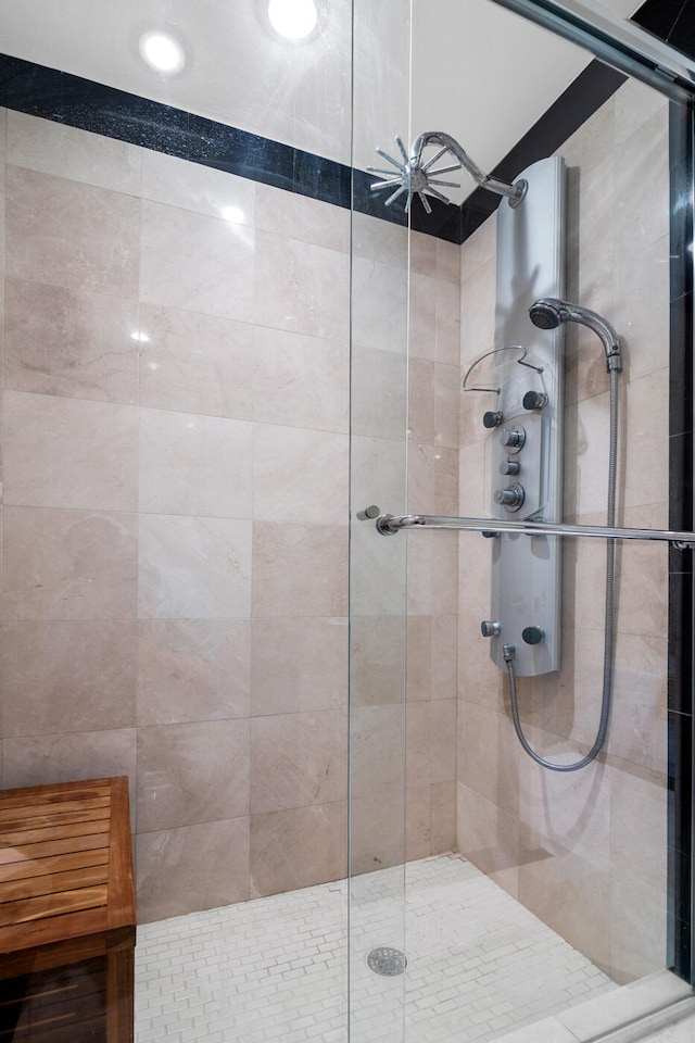 bathroom featuring a shower with shower door