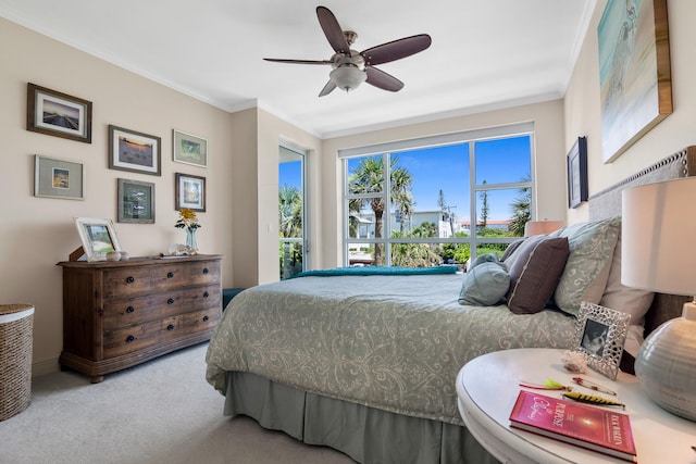 carpeted bedroom with crown molding and ceiling fan