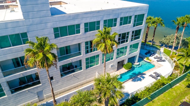 view of property with a community pool and a water view