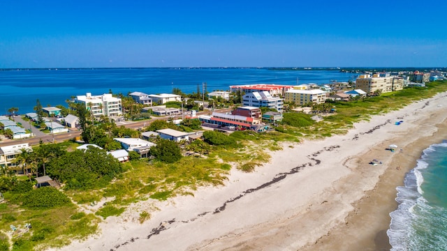 drone / aerial view featuring a view of the beach and a water view