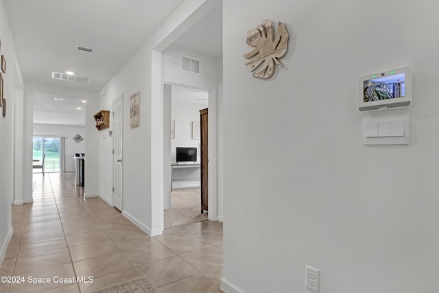 corridor featuring light tile patterned floors