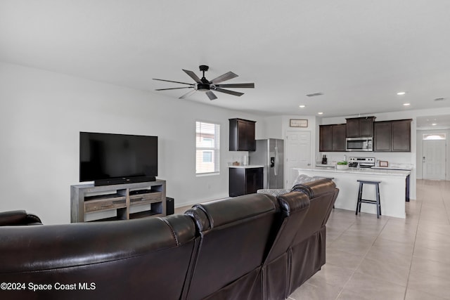 living room featuring ceiling fan and light tile patterned floors