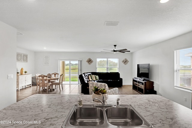 kitchen with ceiling fan, tile patterned flooring, and sink