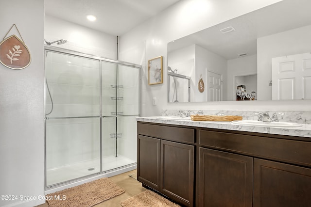 bathroom with tile patterned flooring, vanity, and a shower with door