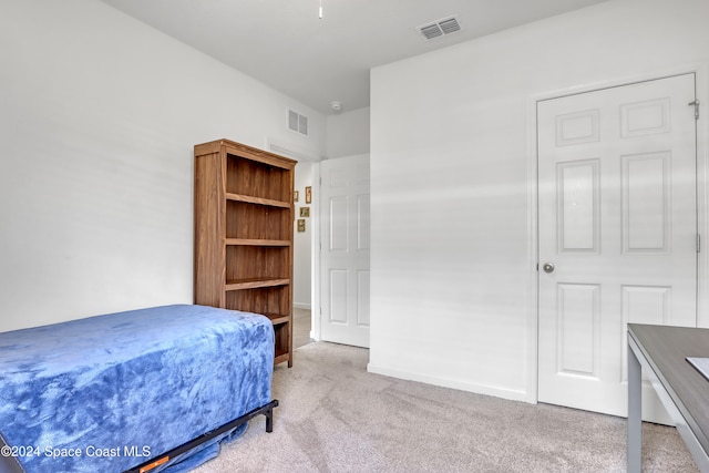 bedroom with light colored carpet