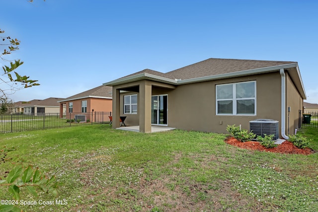 back of house with a patio, central AC, and a yard